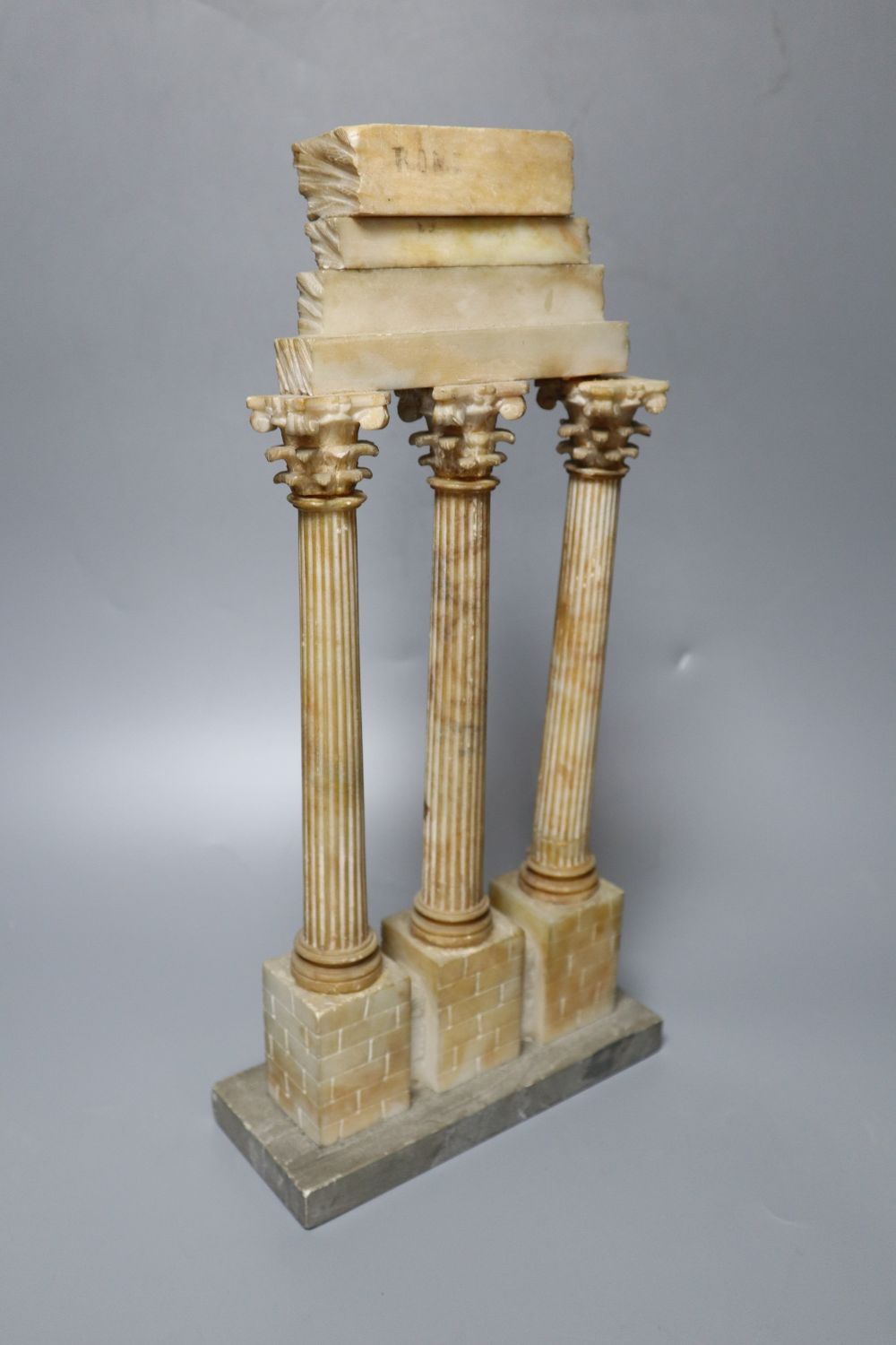 After the Antique. A Grand Tour carved and stained alabaster model of Ruins, height 34cm